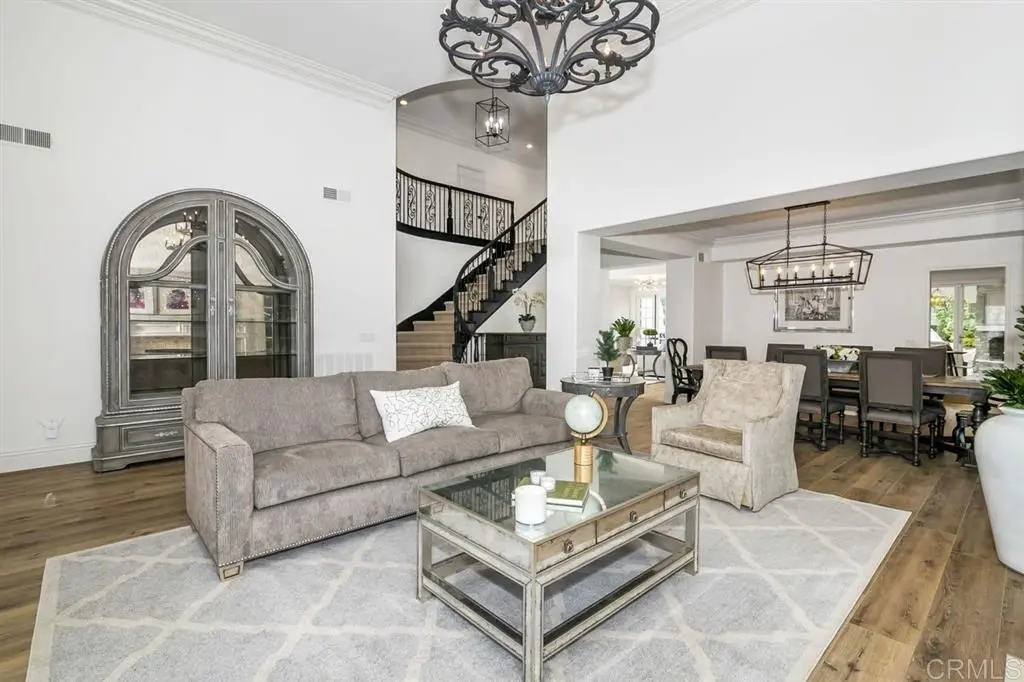 Elegant Encinitas living and dining area with hardwood flooring and plush seating