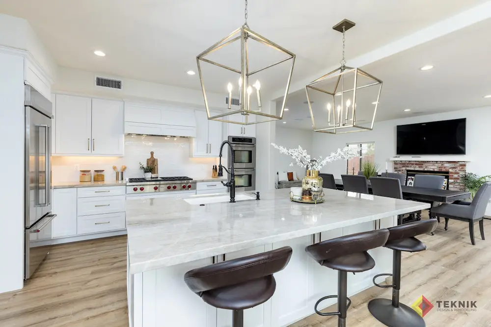 Escondido kitchen remodel featuring white cabinetry, quartz island, and gold pendant lighting