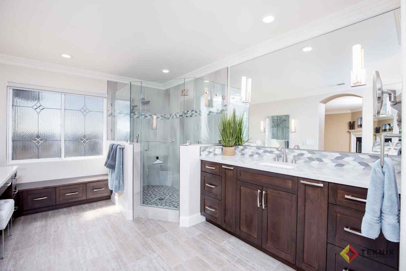 Chula Vista master bathroom remodel with glass shower, dark wood vanity and patterned tile
