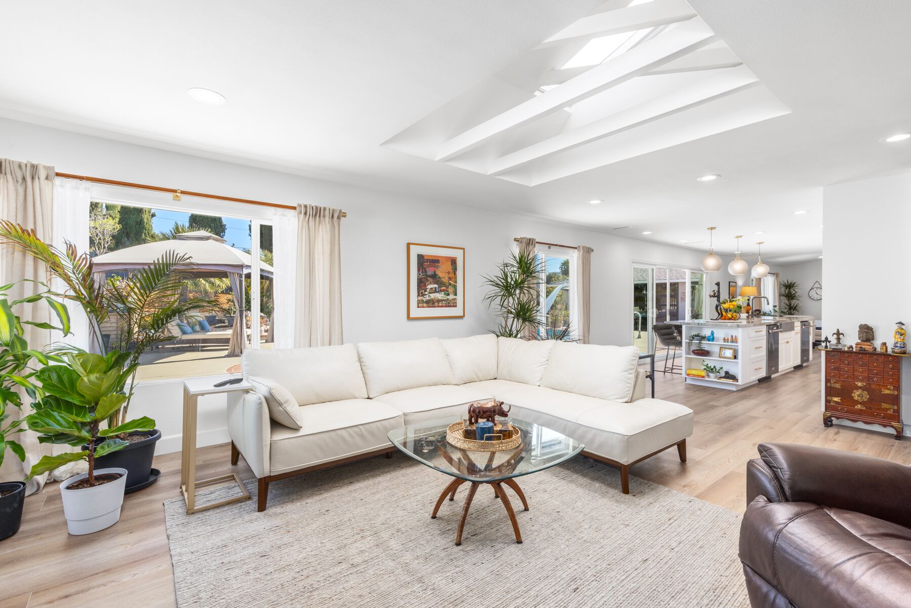 The same living room finished, with a white sectional under the skylights