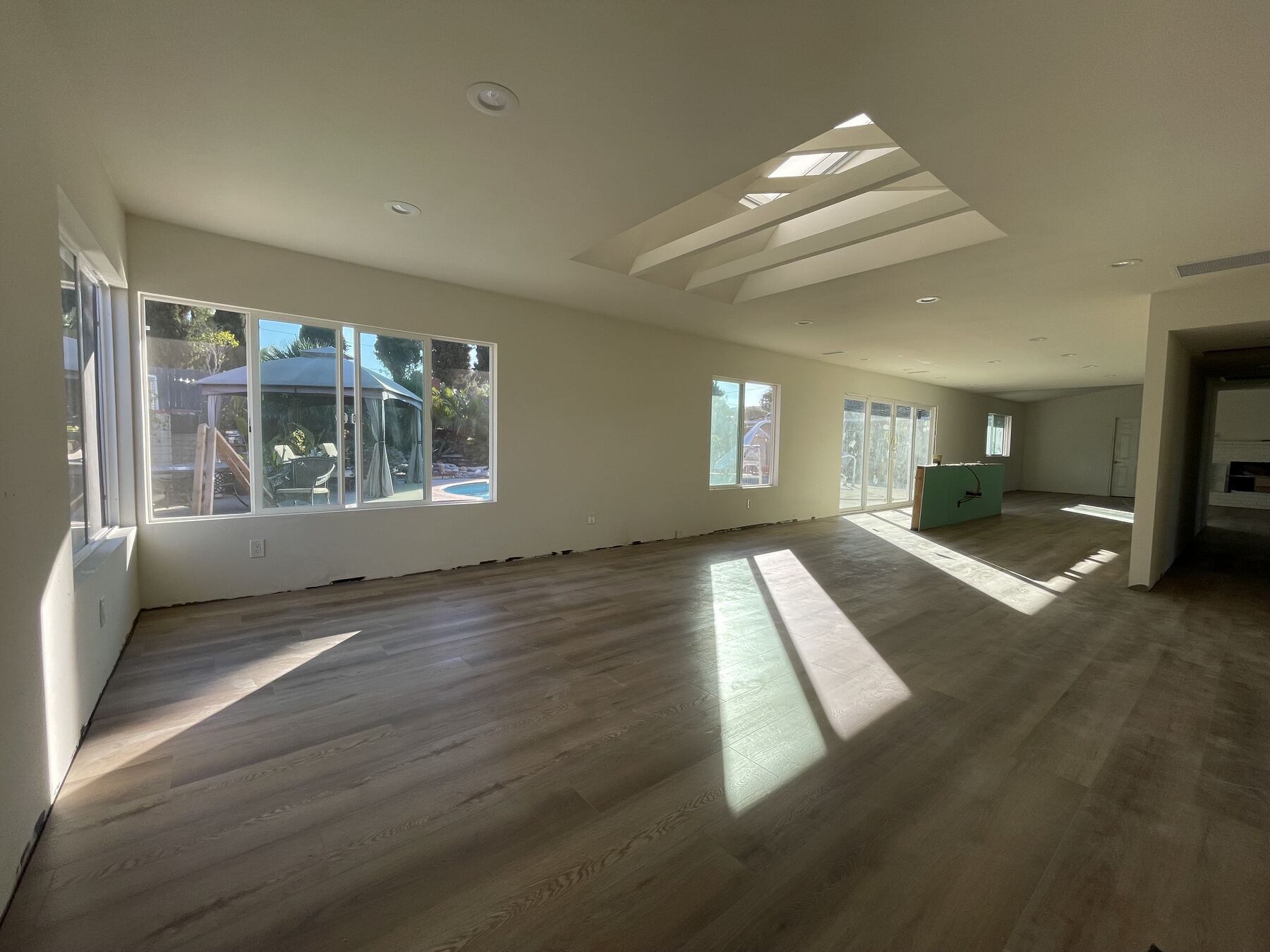 A living room mid-build in a Teknik remodel, with framed skylight wells