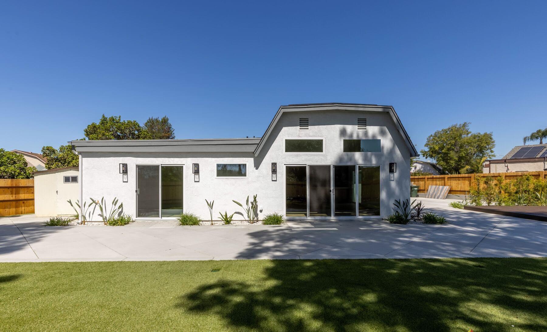 Backyard and rear of a single-story home remodeled by Teknik in San Diego