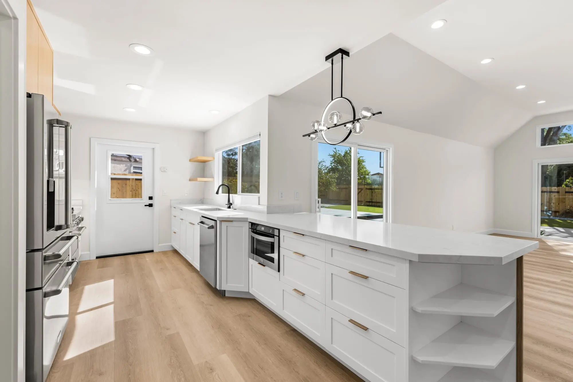 Open-layout kitchen with pendant lighting and modern island