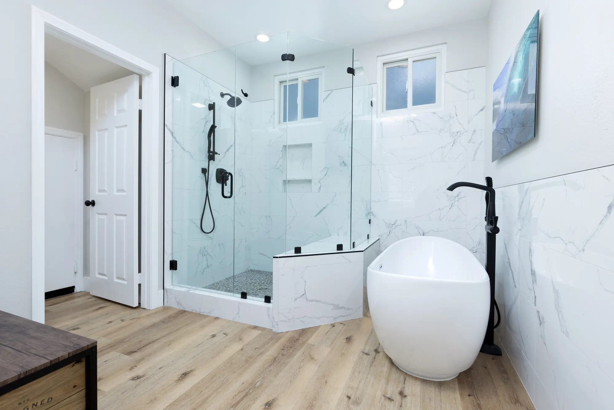 Frameless glass shower beside a freestanding tub in a Carmel Valley primary bathroom remodeled by Teknik