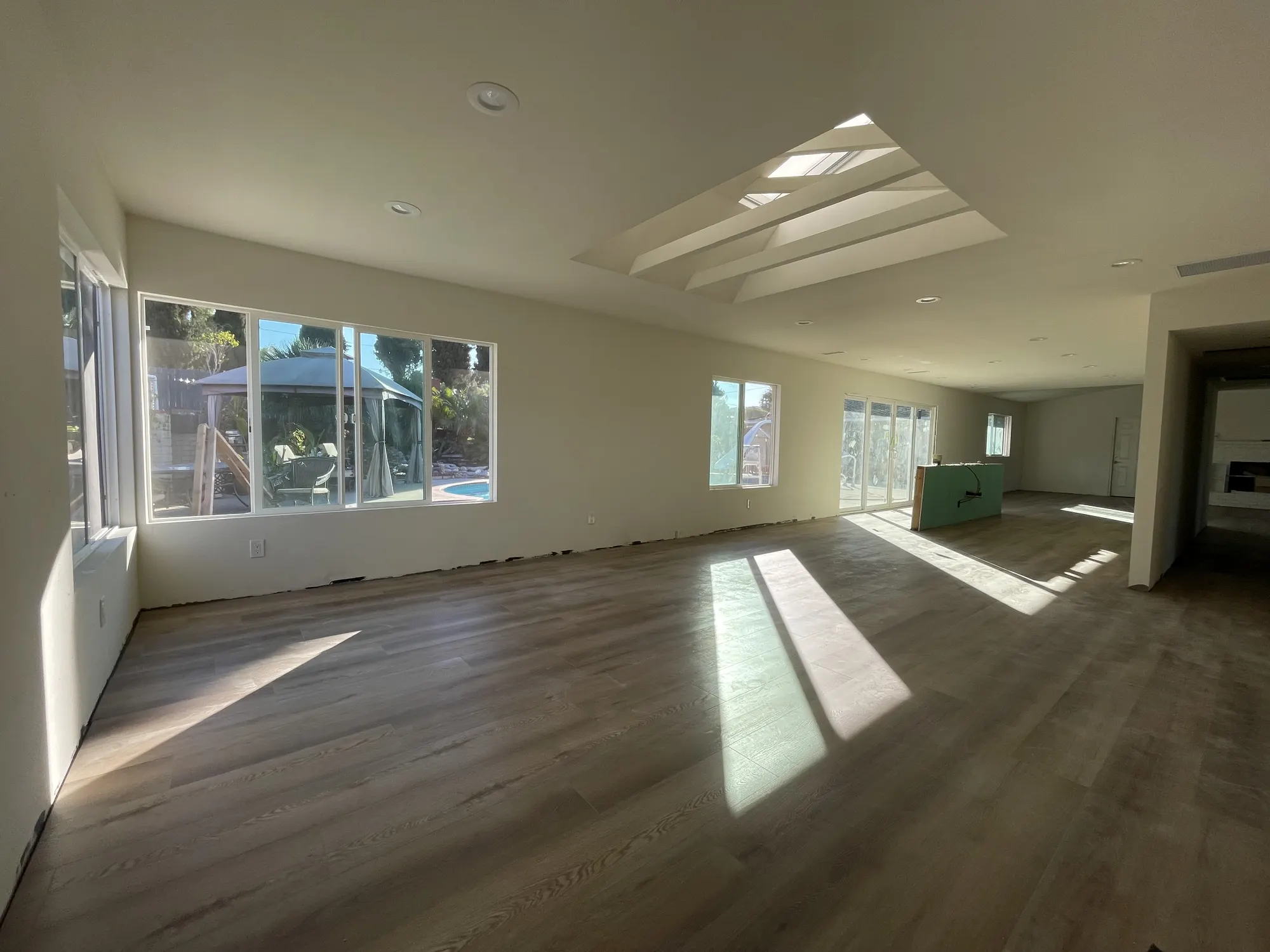 Living room mid-build: empty, with framed skylight wells