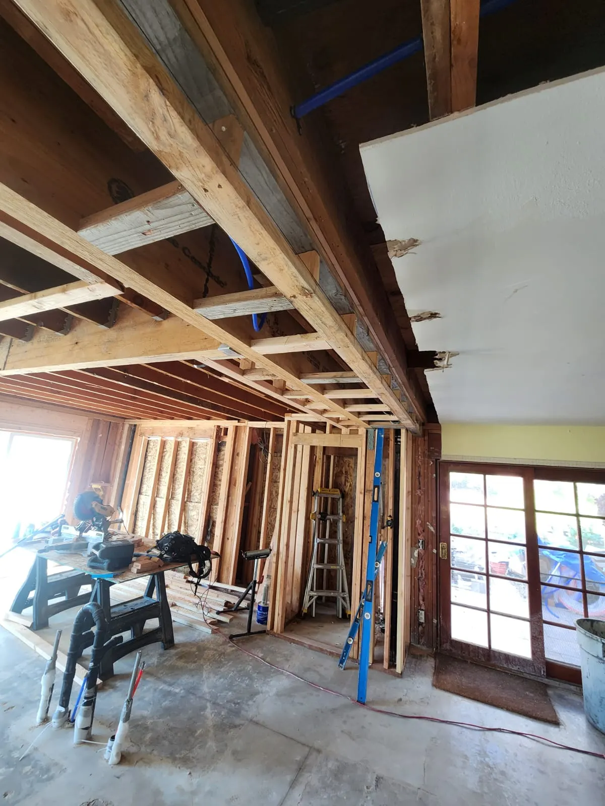 Walls and ceiling opened to the framing for the new layout