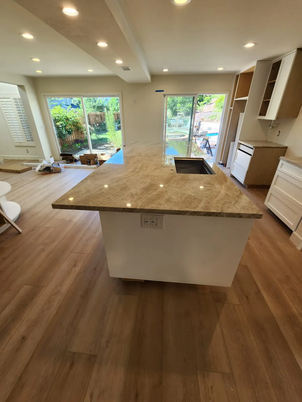 The island topped in stone, with new flooring down