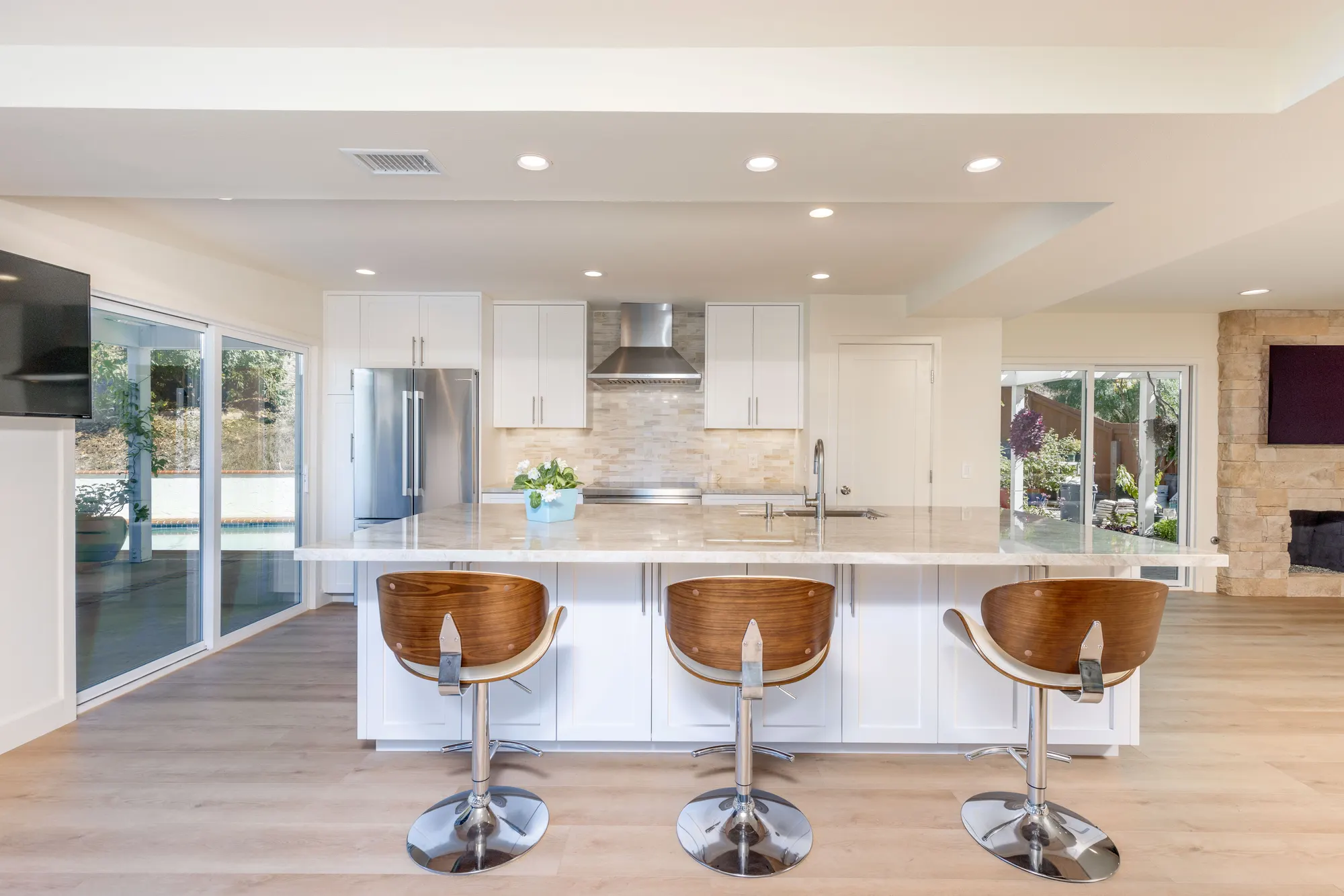 Kitchen island with walnut stools and pendant lights, from a Teknik remodel in nearby Rancho Peñasquitos