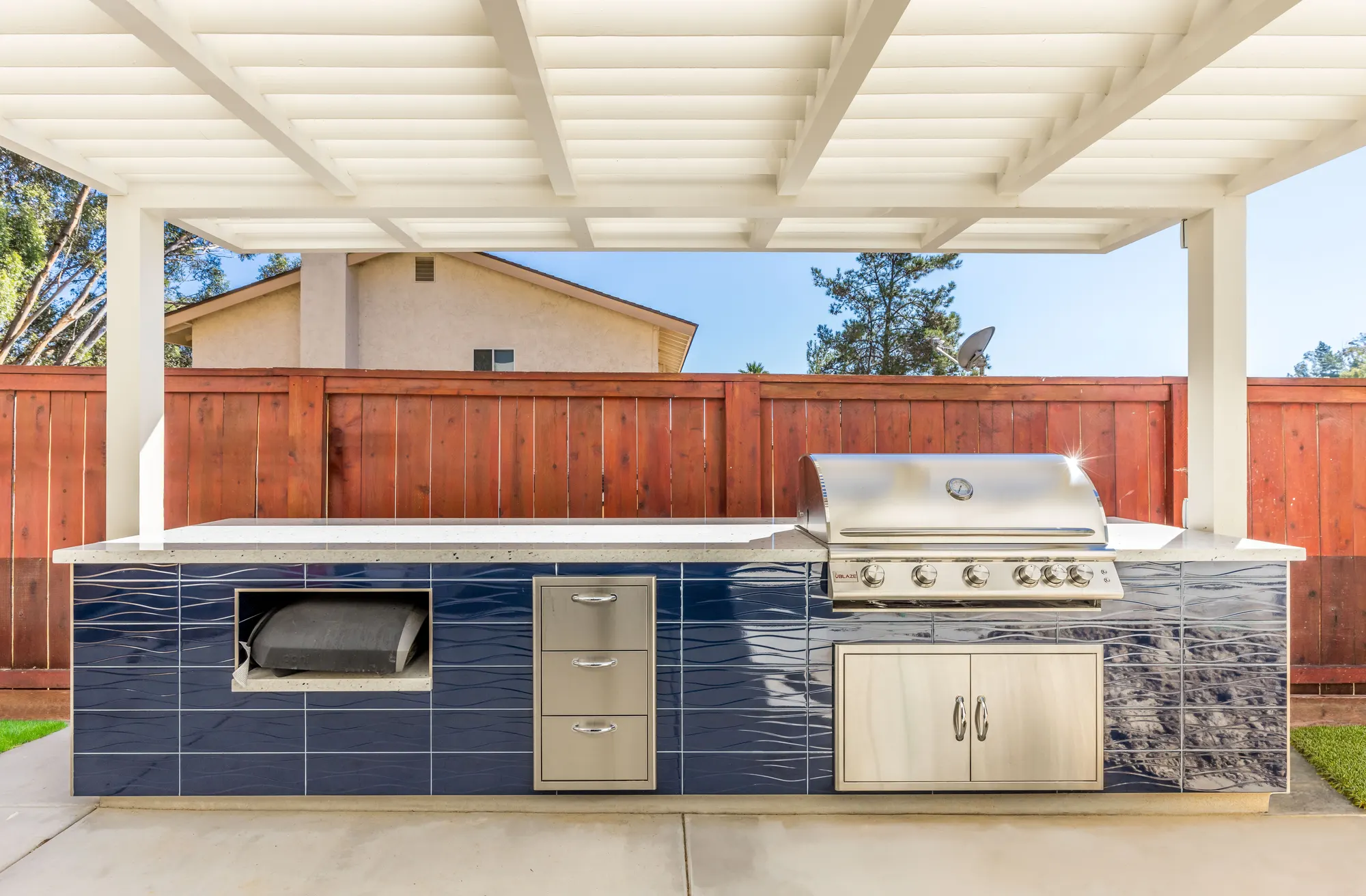 Tiled outdoor kitchen with a built-in grill, from a Teknik remodel in Scripps Ranch