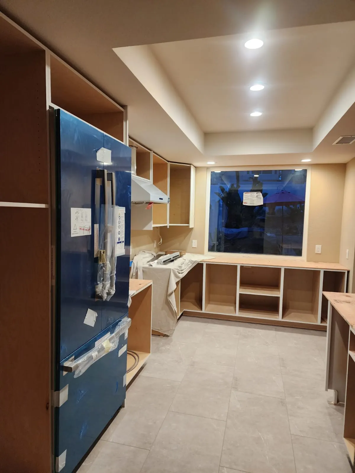 Cabinet boxes in place around the refrigerator